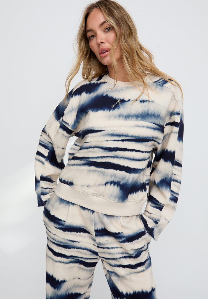 Woman wearing a tie-dye outfit on a white background
