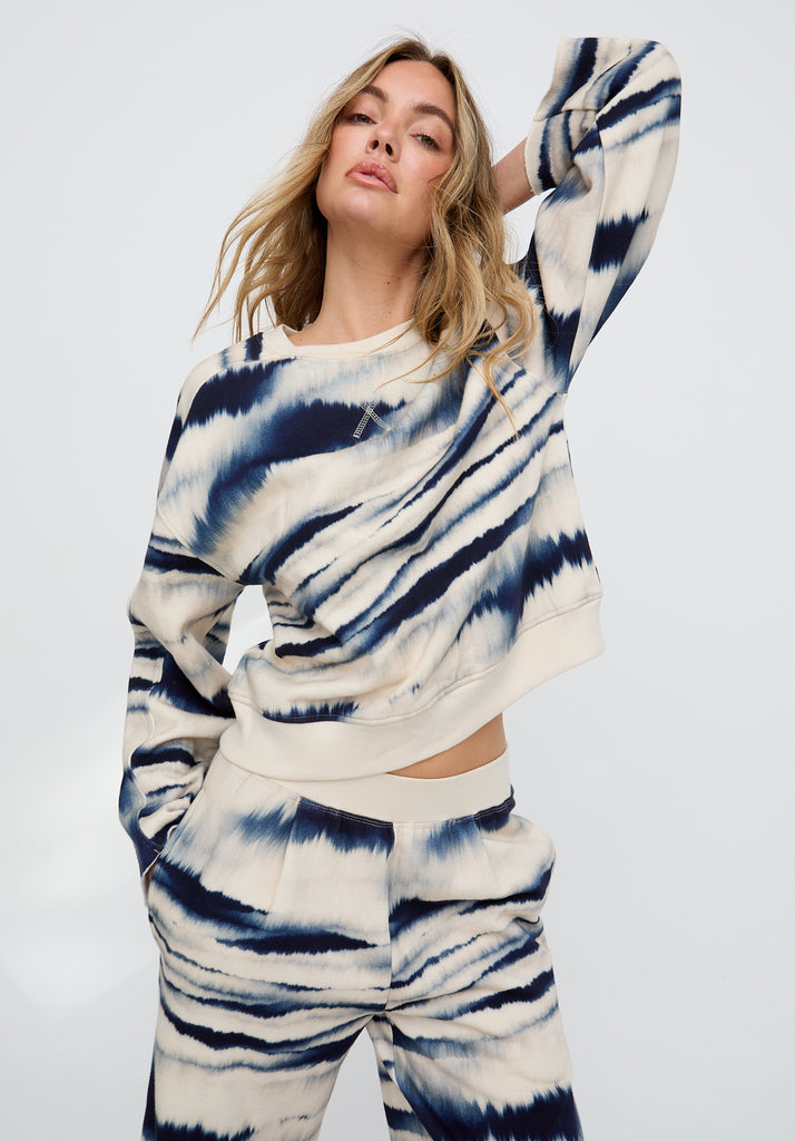 Woman wearing a tie-dye outfit on a white background