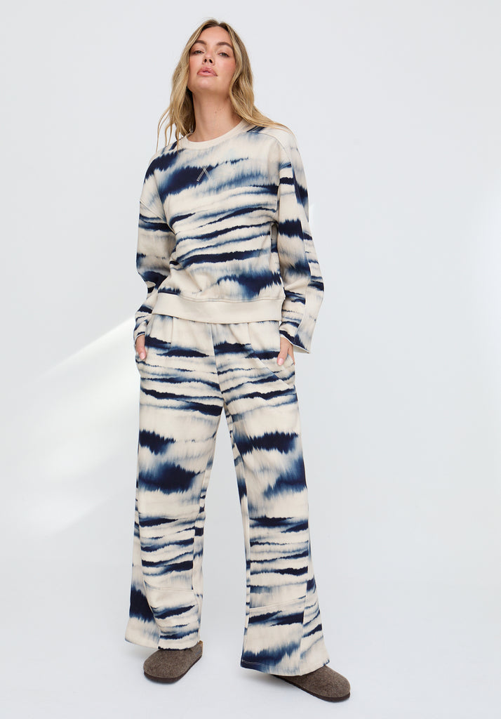 Woman wearing a tie-dye outfit on a white background