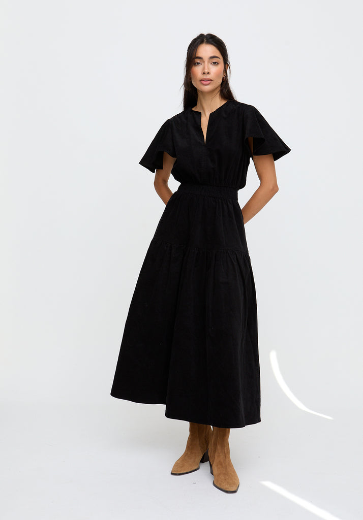 Woman wearing a black dress on a white background