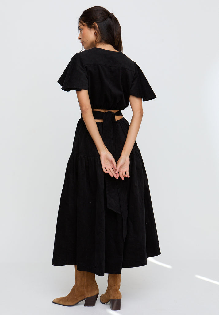 Woman wearing a black outfit with a white background