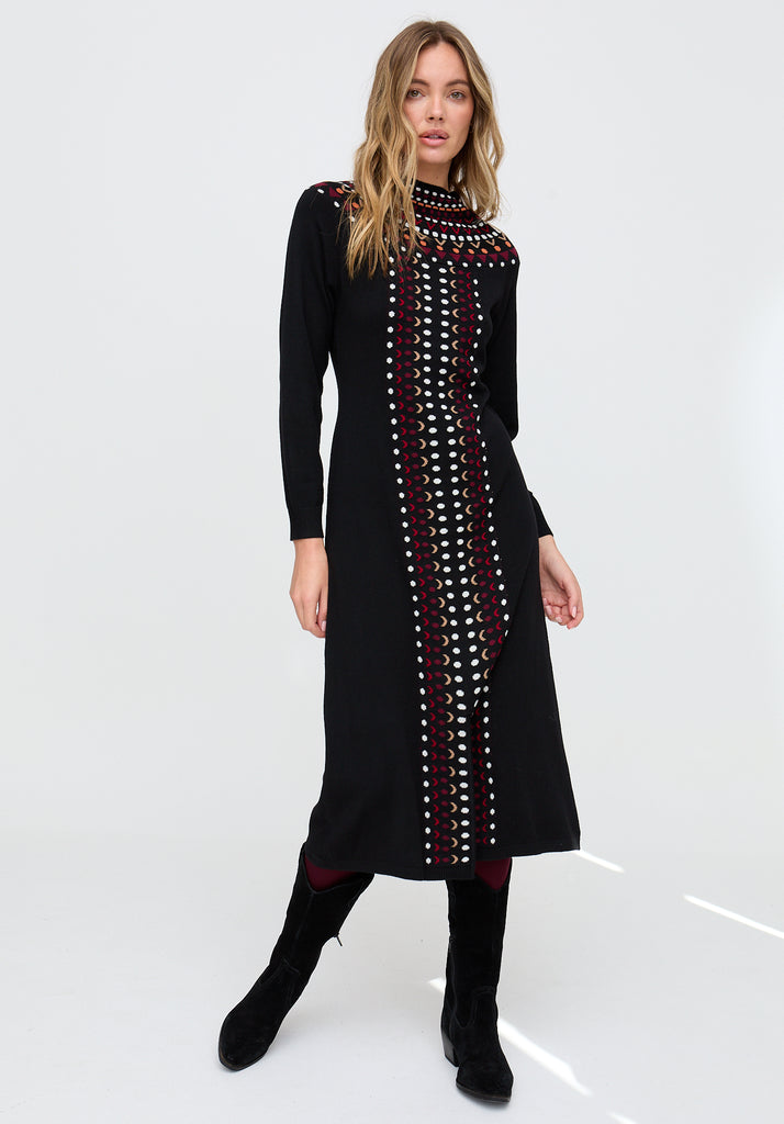 Woman wearing a black dress with red and white pattern on a white background