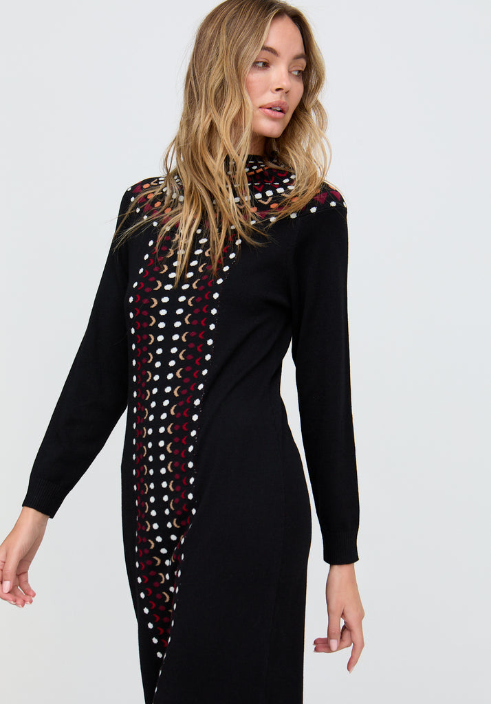 Woman wearing a black dress with a patterned scarf on a white background