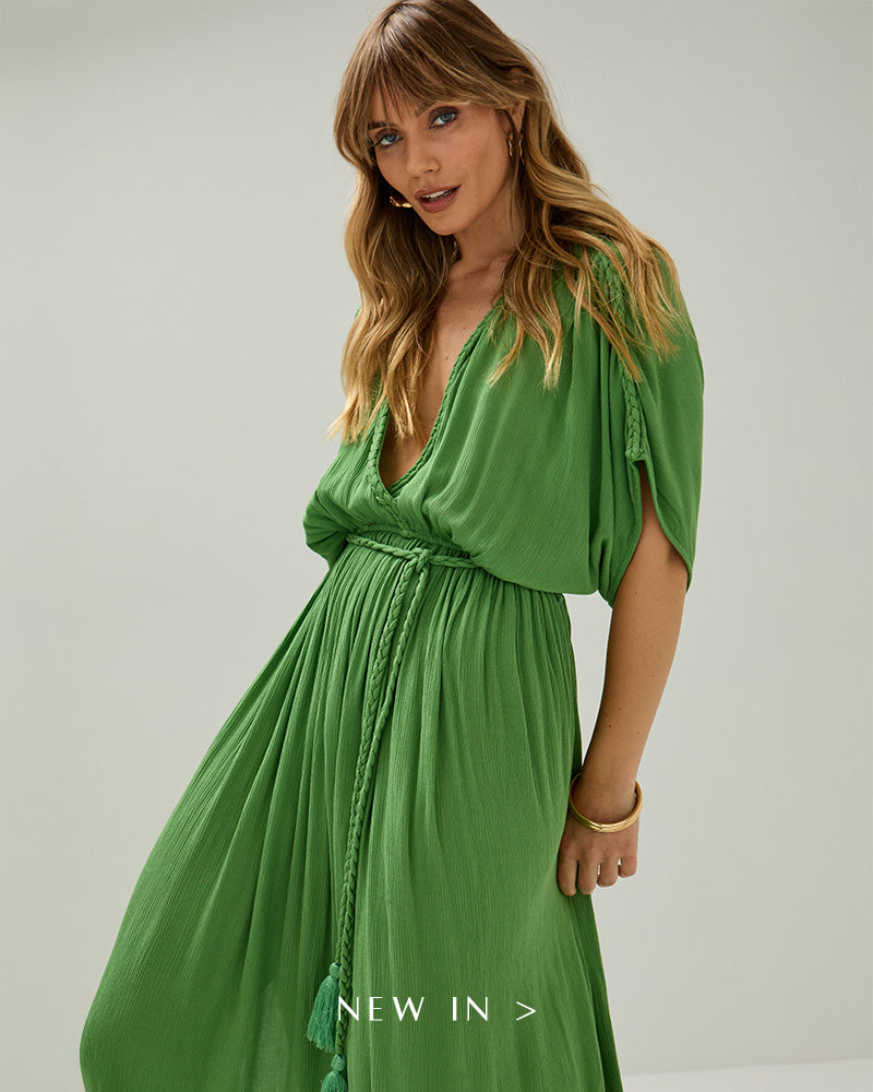 Model wears our Diamond Plait Neck Maxi Dress In Green. Copy on image 'Shop New In'.