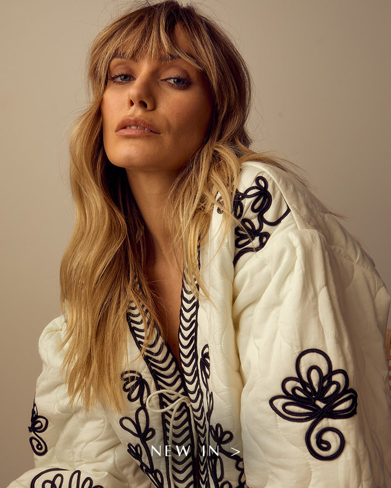 Model wears our Fran Quilted All Over Embroidered Jacket In White. Copy on image 'New In'.