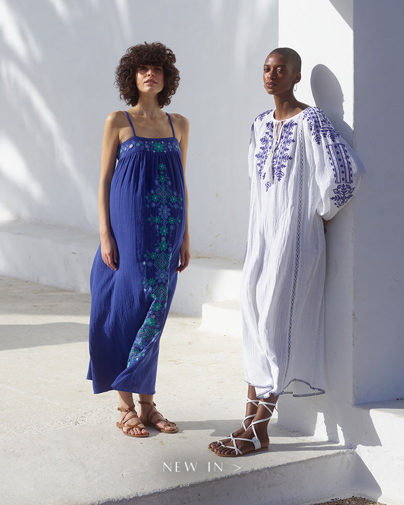 Model on left wears our Thea Spaghetti Strap Embroidered Maxi Dress In Blue. Model on the right styles our Aurelia Kaftan Style Embroidered Maxi Dress In White. Copy on image 'New In'.