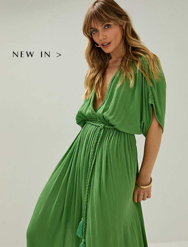 Model wears our Diamond Plait Neck Maxi Dress In Green. Copy on image 'Shop New In'.