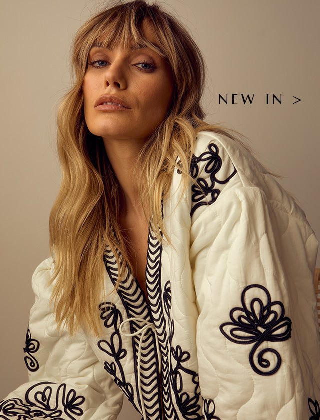 Model wears our Fran Quilted All Over Embroidered Jacket In White. Copy on image 'New In'.