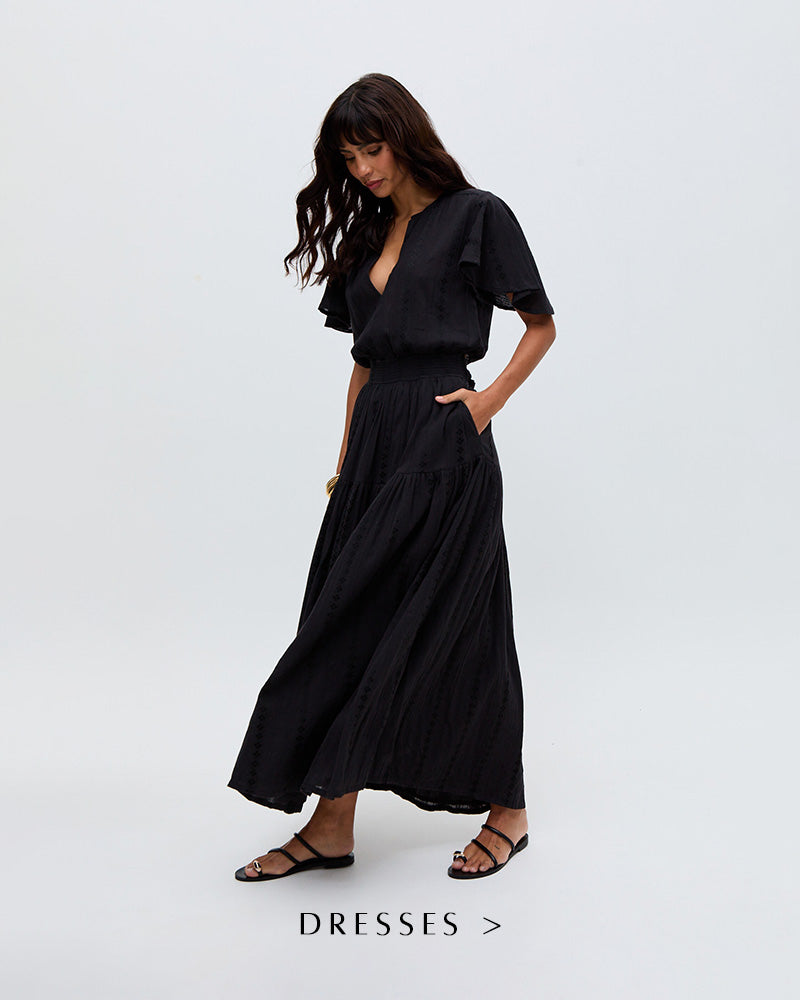 Model wears our Candice Flutter Sleeve Jacquard Maxi Dress In Black. Copy on image 'Shop Dresses'.