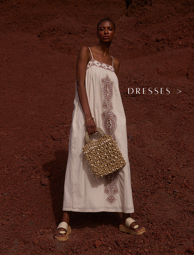 Model styles our Sapphire Spaghetti Strap Embroidered Maxi Dress In Cream. Copy on image 'Dresses'.