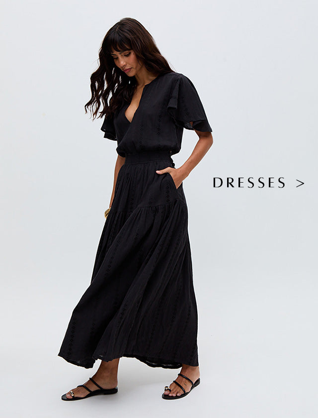 Model wears our Candice Flutter Sleeve Jacquard Maxi Dress In Black. Copy on image 'Shop Dresses'.
