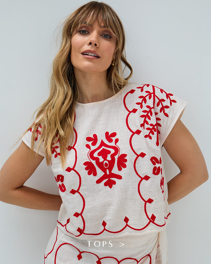 Model wears our Fraya Cross Hatch Embroidered Crop Top In White. Copy on image 'Shop Tops'.