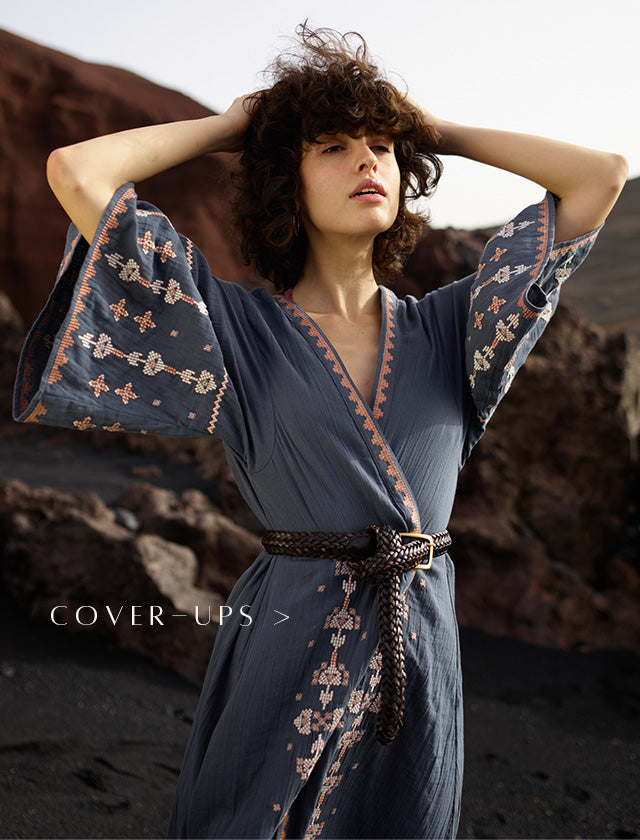 Model wears geometric embroidered kimono in grey, paired with a belt at the waist. Copy on image 'Cover-ups'