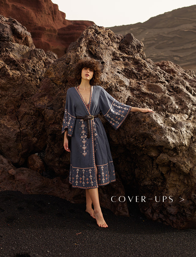 Model wears geometric embroidered kimono in grey, paired with a belt at the waist. Copy on image 'Cover-ups'