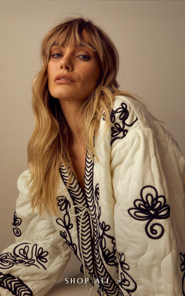 Model wears our Fran Quilted All Over Embroidered Jacket In White. Copy on image 'Shop All'.