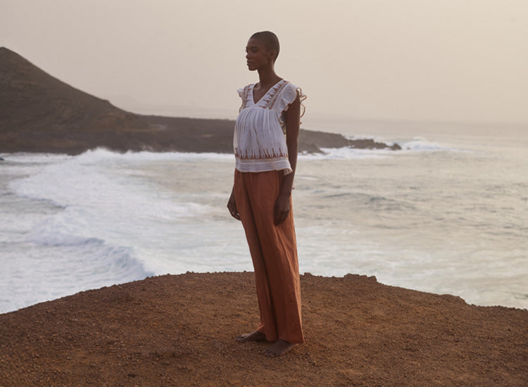 Model styles the Mariana Flutter Sleeve Embroidered Blouse In Cream with our Paulina Wide Leg Trouser In Brown